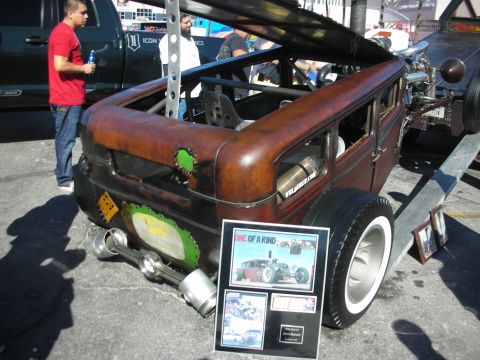 1998 Ford Crown Victoria - A custom hot rod sedan is displayed with a plaque detailing its unique build.
