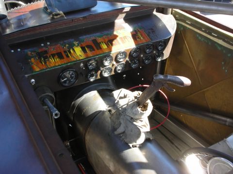 1998 Ford Crown Victoria - Interior view of a custom hot rod, a dashboard with numerous gauges and a prominent shifter.