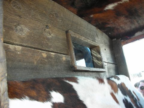 1998 Ford Crown Victoria - Interior view of a rustic wooden structure cowhide upholstery on the seating and ceiling.