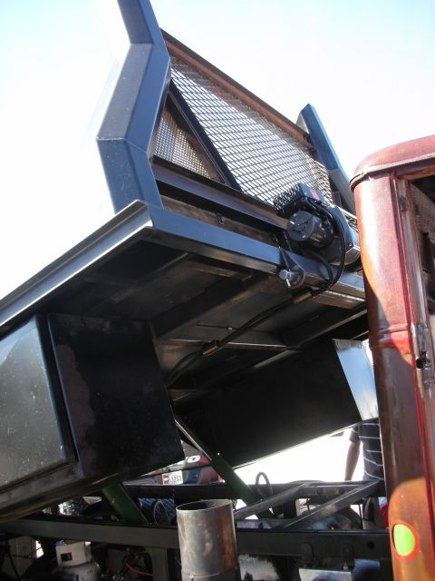 1998 Ford Crown Victoria - Close-up view of the hydraulic lift mechanism for a dump truck bed, showing its complex construction.