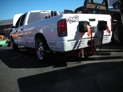 1998 Ford Crown Victoria - Rear view of a white Dodge Ram pickup truck with custom modifications and decals.