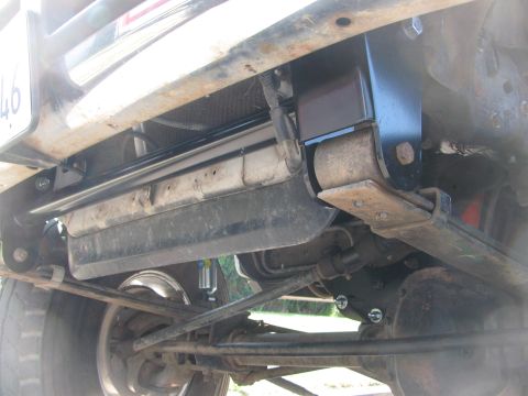1996 Ford C-350 (Centurion Conversions) - Close-up view of the front suspension and radiator area of a vehicle.