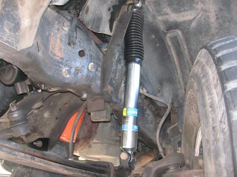 1996 Ford C-350 (Centurion Conversions) - Close-up view of a Bilstein shock absorber installed on a vehicle's suspension system.