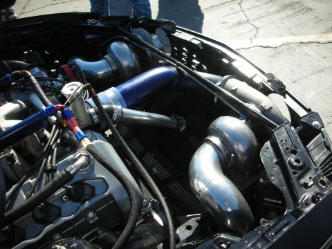 1998 Ford Crown Victoria - Custom twin-turbo engine setup with polished intercooler piping and braided hoses.