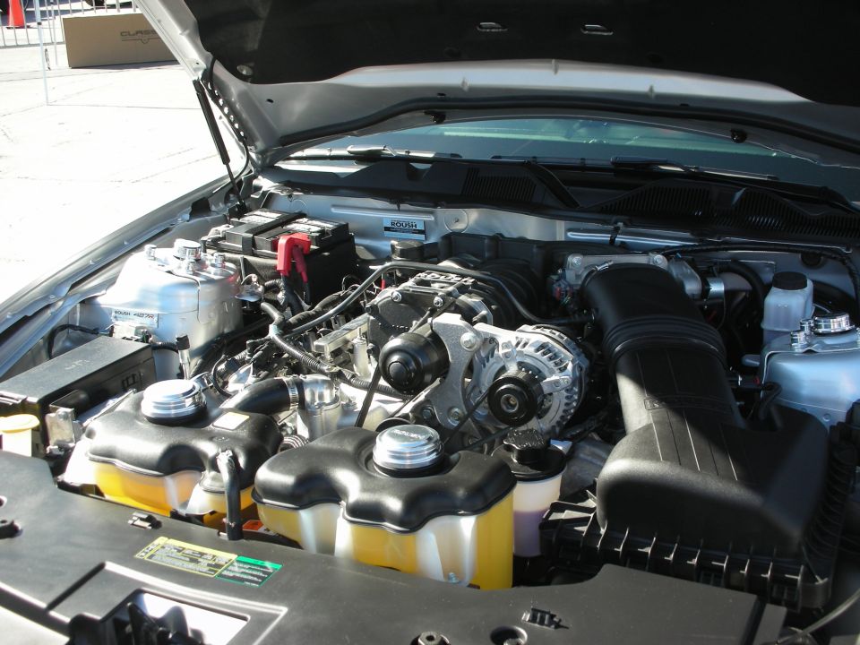 Engine bay with supercharger, silver car
