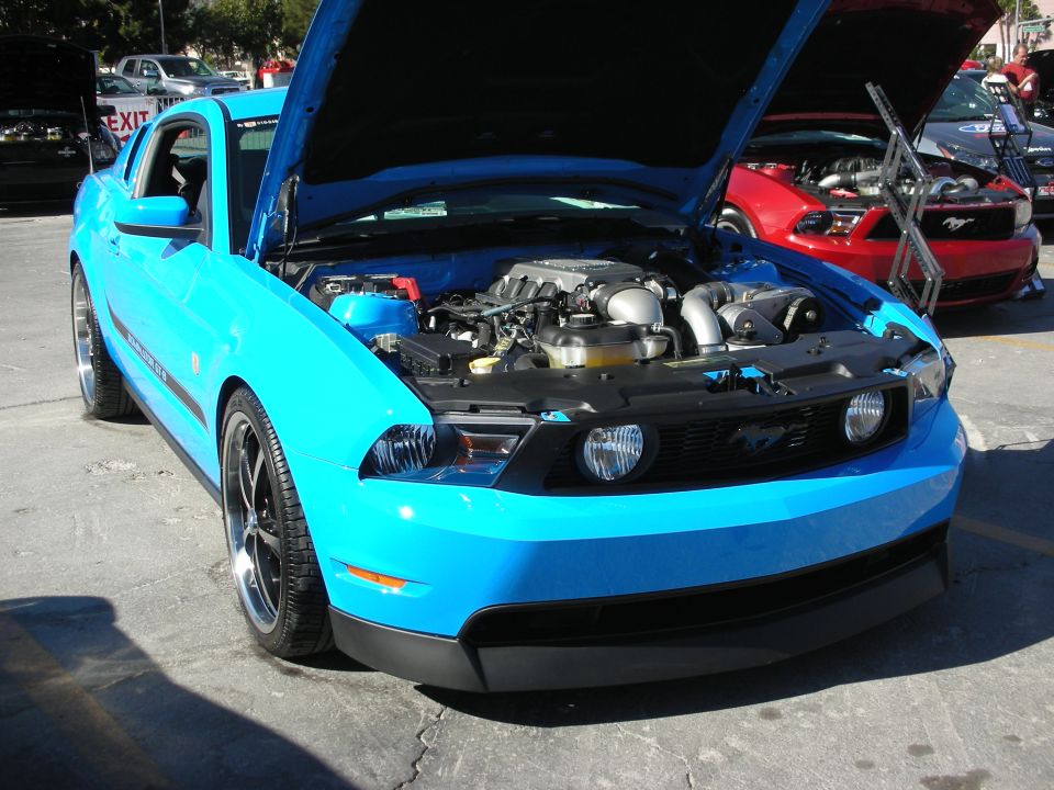 Blue Ford Mustang front view, hood open showing engine