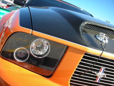 1998 Ford Crown Victoria - Front view of an orange Ford Mustang a carbon fiber hood and grille.