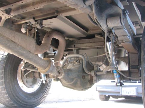 1996 Ford C-350 (Centurion Conversions) - The rear suspension and drivetrain components of a truck are shown from underneath.