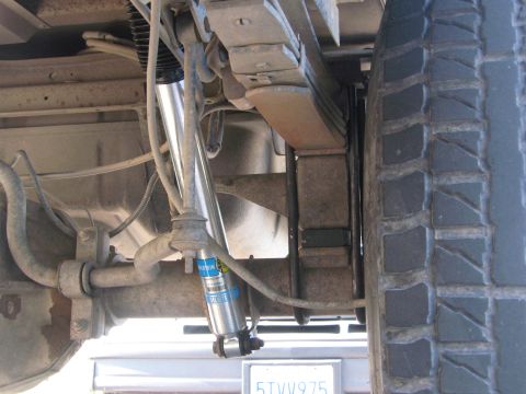1996 Ford C-350 (Centurion Conversions) - Rear suspension components and tire of a vehicle. A license plate is visible below.