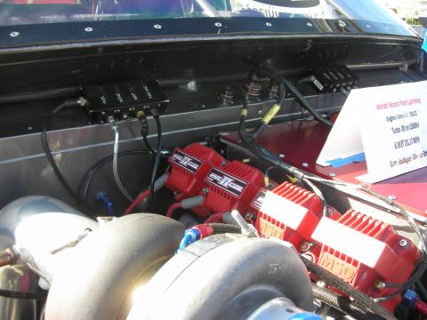 1998 Ford Crown Victoria - Close-up of a modified engine bay twin turbochargers and high-performance ignition components.