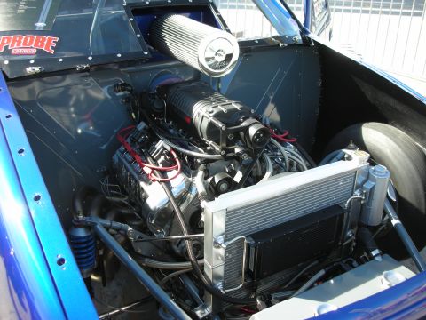 1998 Ford Crown Victoria - Close-up view of a custom-built engine bay a prominent supercharger and cooling system.