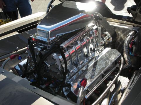 1998 Ford Crown Victoria - Close-up of a highly polished V8 engine with a supercharger and custom valve covers.