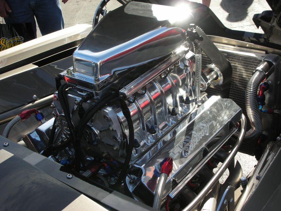 Chrome supercharger and valve covers on a V8 engine, with braided fuel lines