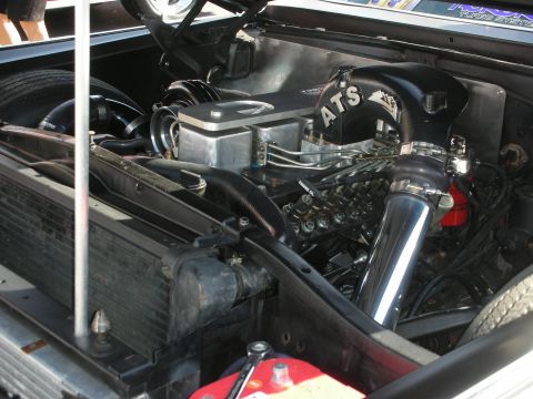 1998 Ford Crown Victoria - Close-up of a modified engine bay, a prominent ATS turbocharger and polished intake components.