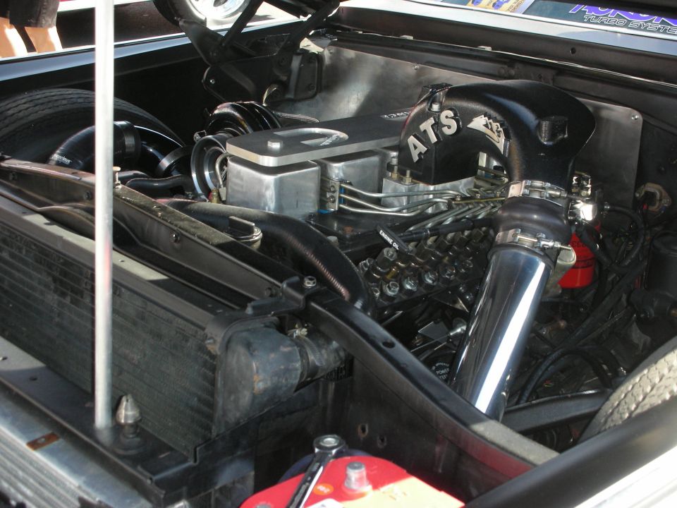 Engine bay with ATS turbocharger and custom intake piping. Chrome intake tube visible