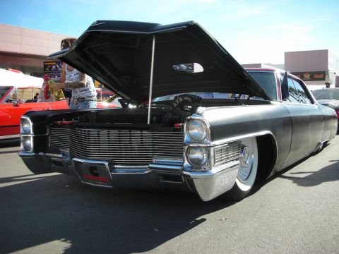 1998 Ford Crown Victoria - A black Cadillac is displayed with its hood up, revealing the engine bay.