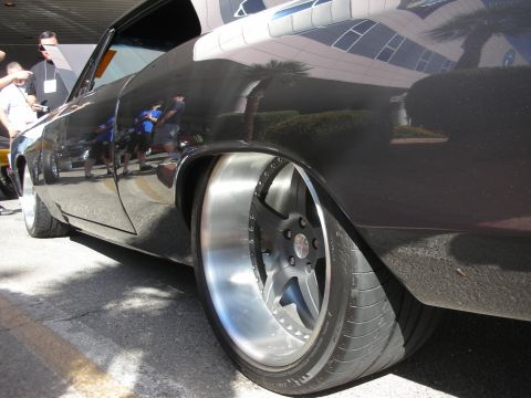1998 Ford Crown Victoria - Close-up of a custom car's rear wheel and fender, showing aftermarket modifications.