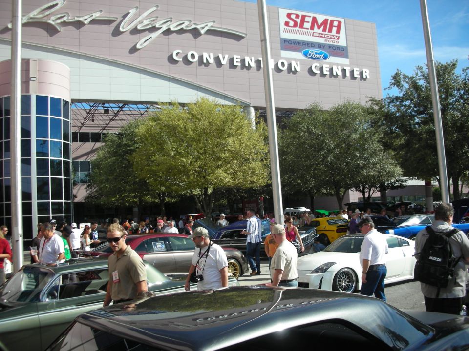 Cars parked outside Las Vegas Convention Center with SEMA Show sign
