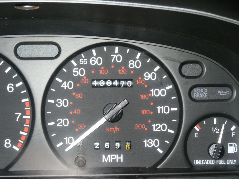 Car gauge cluster with speedometer, odometer 138470, and fuel gauge