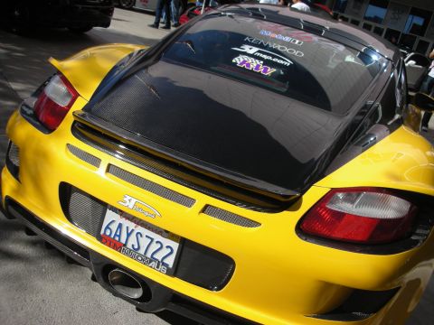 1998 Ford Crown Victoria - Rear view of a yellow sports car a carbon fiber engine cover and aftermarket exhaust.