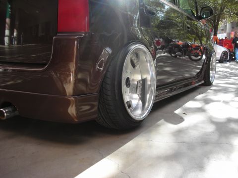 1998 Ford Crown Victoria - A modified car with large chrome wheels and a lowered stance is parked outdoors.