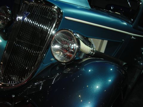 1998 Ford Crown Victoria - Close-up of a vintage car's front end, highlighting its grille and headlight details.