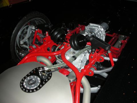 1998 Ford Crown Victoria - A custom fuel filler cap is visible alongside the red-painted suspension components of a vehicle.