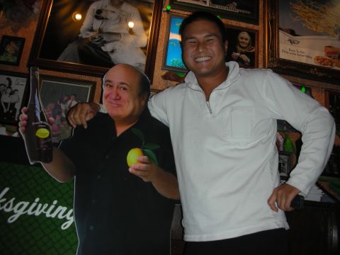 1998 Ford Crown Victoria - A man stands with a cutout of Danny DeVito, who is holding a bottle and a lemon.