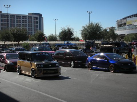 1998 Ford Crown Victoria - Modified vehicles are parked in an outdoor lot under a clear blue sky.
