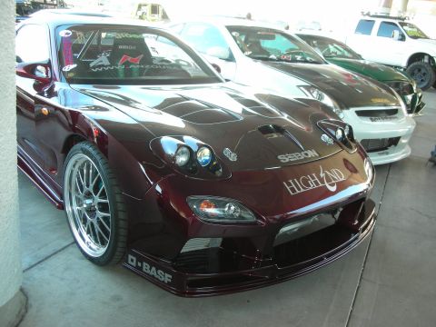 1998 Ford Crown Victoria - Modified Mazda RX-7 FD with racing seats and aftermarket body kit parked in a line with other vehicles.