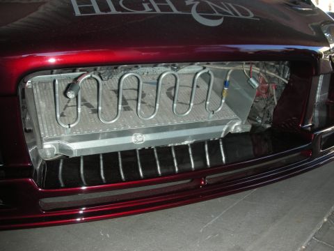 1998 Ford Crown Victoria - The vehicle's front end features a custom grille and an exposed radiator, with 'HIGH END' lettering visible on the hood.