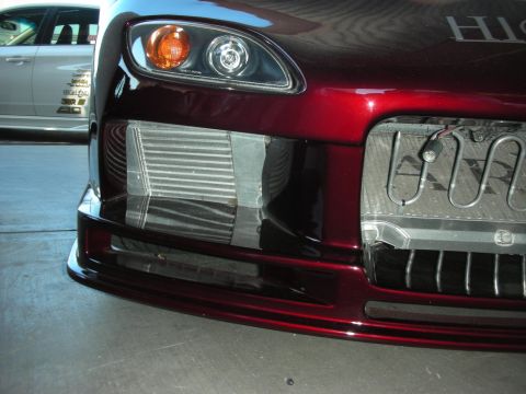 1998 Ford Crown Victoria - The front of a red sports car is shown, with a visible intercooler and radiator.