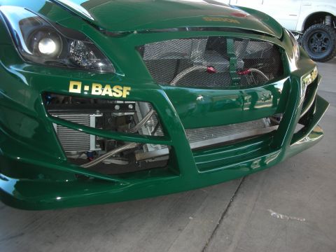 1998 Ford Crown Victoria - Front view of a green race car a prominent BASF logo on the bumper and a large, exposed grille.