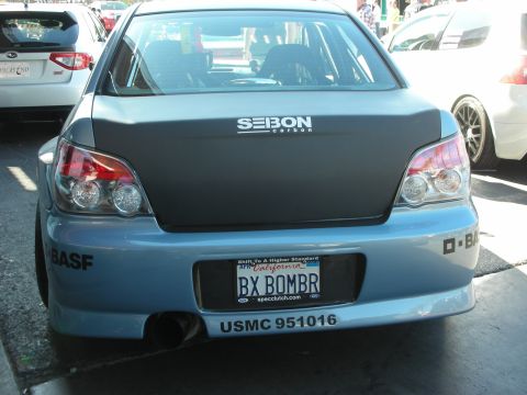 1998 Ford Crown Victoria - Rear view of a modified Subaru WRX STI hatchback with a carbon fiber trunk and custom license plate.