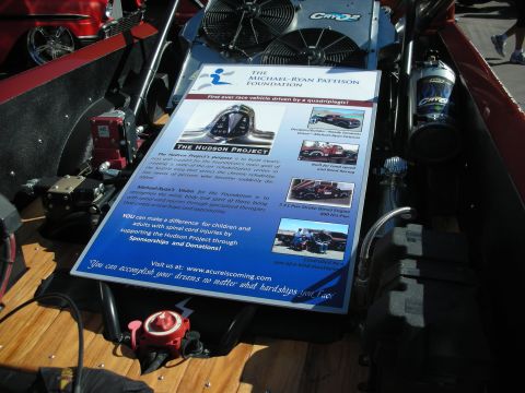 1998 Ford Crown Victoria - A document detailing the Hudson Project and its mission is displayed in the engine bay of a vehicle.