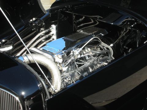 1998 Ford Crown Victoria - Close-up view of a polished engine bay with intricate chrome detailing.