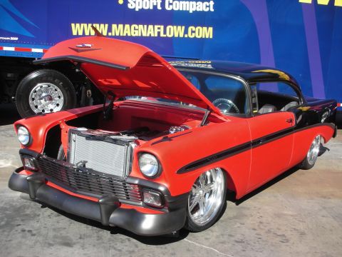1998 Ford Crown Victoria - Customized 1956 Chevrolet Bel Air with a two-tone paint job and aftermarket wheels is displayed with its hood up.
