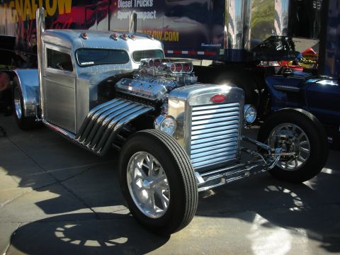 1998 Ford Crown Victoria - A custom-built hot rod truck with a powerful V8 engine is parked outdoors.