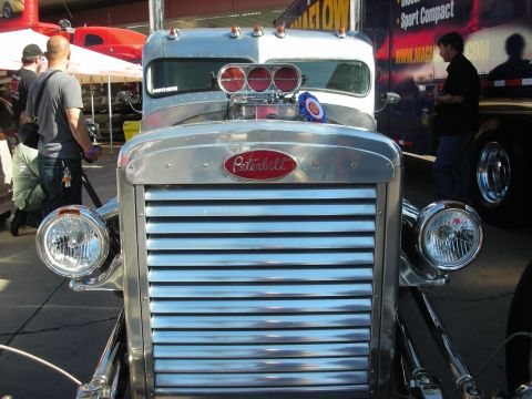 1998 Ford Crown Victoria - A custom Peterbilt truck is displayed with a prominent chrome grille and engine details visible.