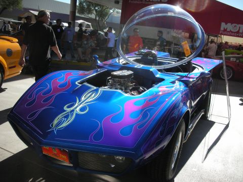 1998 Ford Crown Victoria - This custom hot rod features a unique bubble canopy and a vibrant flame paint job over its exposed engine.