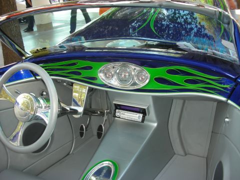 1998 Ford Crown Victoria - The interior of a custom hot rod features a unique dashboard with flame graphics and a modern stereo system.