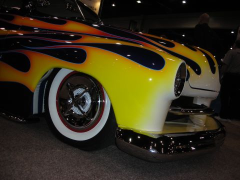 1998 Ford Crown Victoria - A custom hot rod displays a vibrant flame paint job and classic whitewall tires.