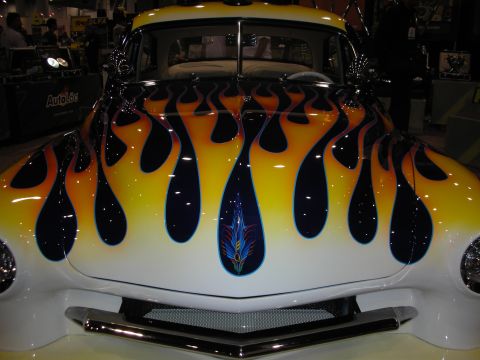 1998 Ford Crown Victoria - Custom hot rod with flame paint job and chrome accents displayed indoors.