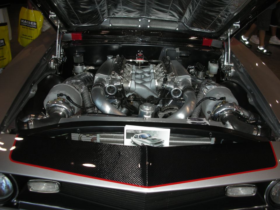 Engine bay with twin turbochargers, custom intake manifold, and carbon fiber accents