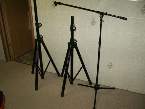 1990 Ford Bronco - Three black microphone stands are arranged indoors, with two on the left and one on the right.