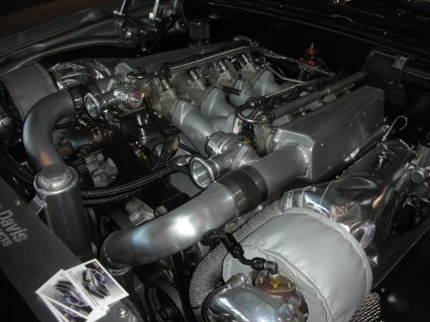 1998 Ford Crown Victoria - A highly modified engine bay features twin turbochargers and a polished intake manifold, suggesting significant performance upgrades.