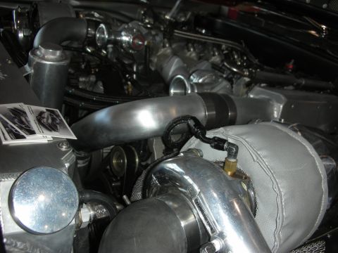 1998 Ford Crown Victoria - Custom engine bay features polished intake piping and a turbocharger with a heat shield.