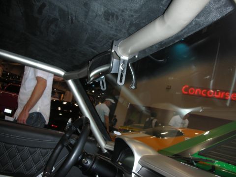 1998 Ford Crown Victoria - Custom car interior with roll cage and diamond-stitched seats, seen at a car show.