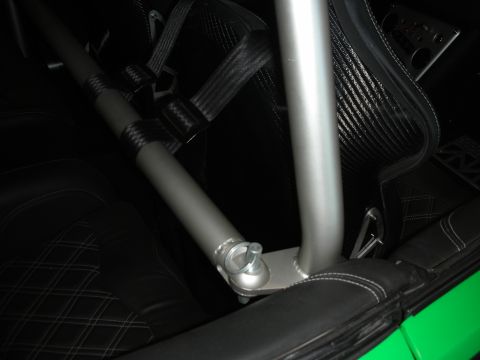 1998 Ford Crown Victoria - Close-up view of a vehicle's interior, highlighting the roll cage and custom racing seats.