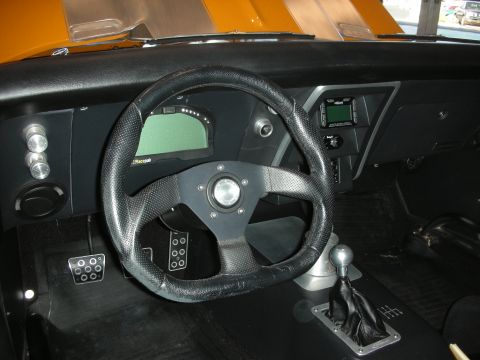 1998 Ford Crown Victoria - Aftermarket digital dashboard and steering wheel installed in a car's interior.